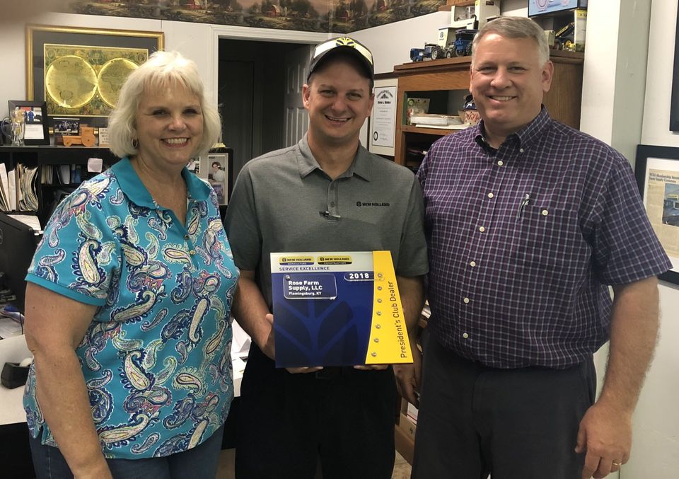 Owners, Regina Rose and Kenney Gulley, are awarded the New Holland President's Club Award by New Holland Aftersales Business Manger, Andrew Wood